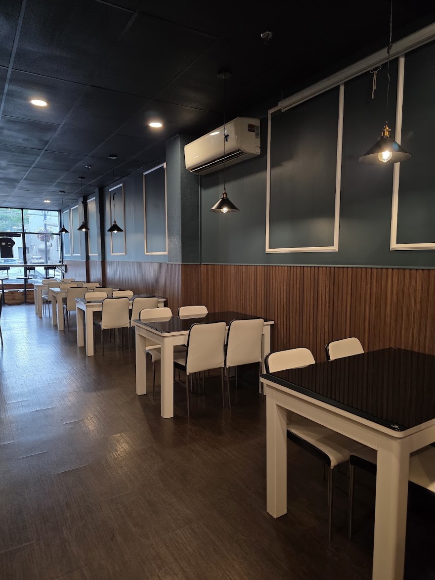 Tables set along the window side of Delhi Darbar's dining room